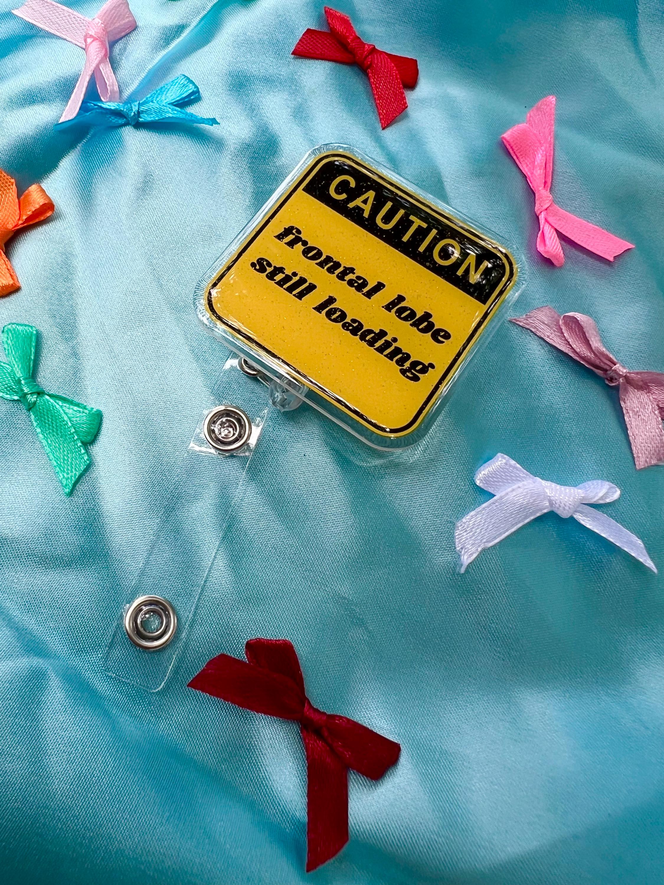 Funny "Frontal Lobe Still Loading" Glitter Badge Reel | Caution Sign Retractable ID Holder for Gen Z Nurses, Students & Teachers